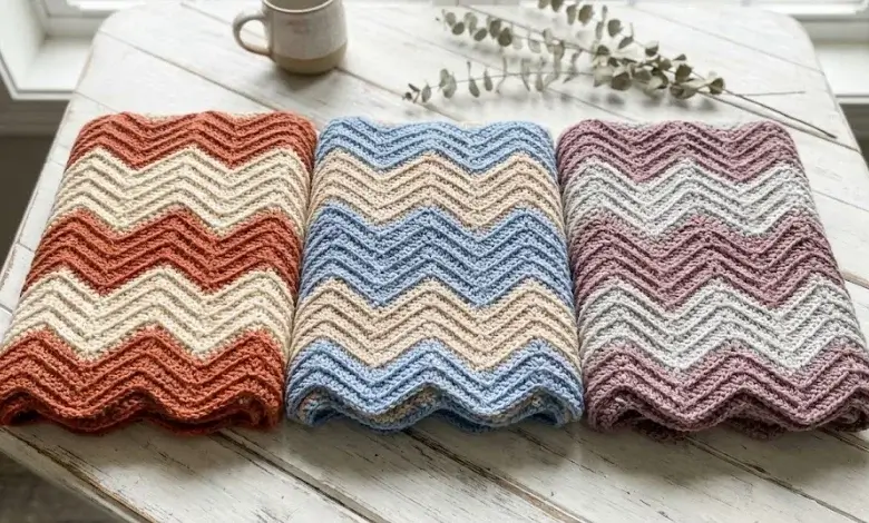 Terracotta and burnt orange crochet chevron throw blanket draped over a beige sofa